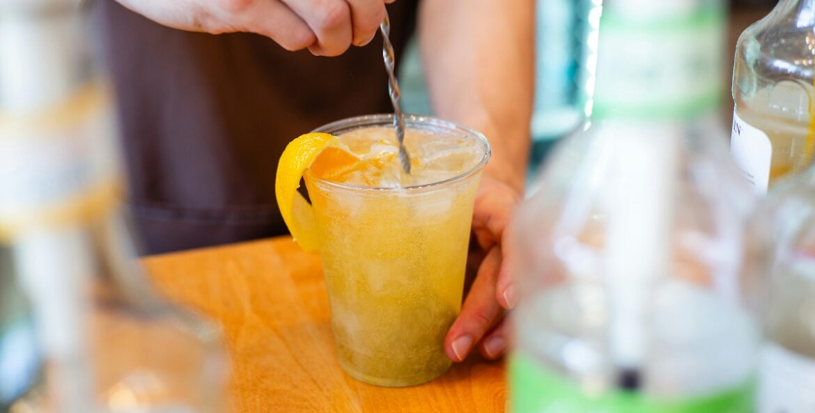 A bartender prepares a mixed drink for delivery as cocktails to-go is made permanent in Illinois.