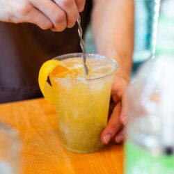 A bartender prepares a mixed drink for delivery as cocktails to-go is made permanent in Illinois.