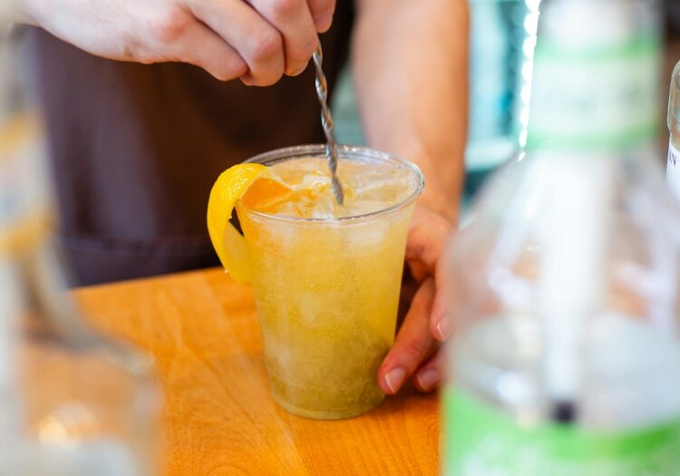 A bartender prepares a mixed drink for delivery as cocktails to-go is made permanent in Illinois.
